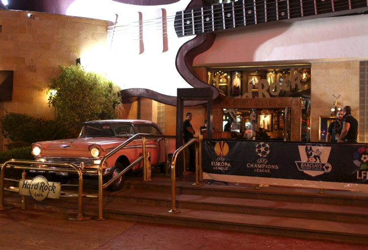 Employees wait at the entrance of Hard Rock Cafe in the Red Sea resort of Sharm el-Sheikh, Egypt November 10, 2015. The fallout from the crash of a Russian Metrojet passenger plane in Egypt's Sinai Peninsula could slash tourism income from Sharm al-Sheikh by half, the head of the region's travel agents' association said on Tuesday. Several airlines have suspended flights to the Red Sea resort since the Oct. 31 crash, which investigators and Western governments believe was likely to have been caused by a bomb. Thousands of Russian and British tourists have been flown home. REUTERS/Asmaa Waguih