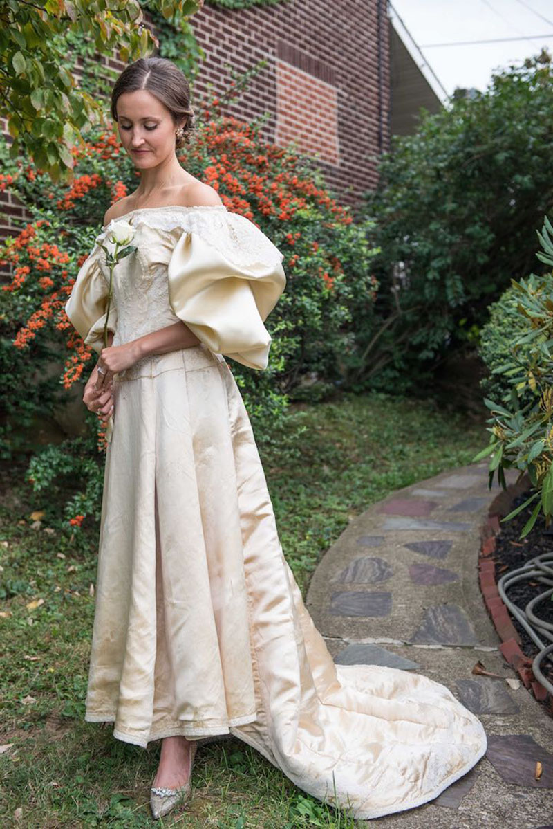 Abigail Kingston tries on a wedding dress, Sept. 22, 2015 that has been passed down in her family for over 100 years and will be the 11th bride to wear it.  Easton-area designer Deborah Lopresti put in 200 hours to restore the dress.