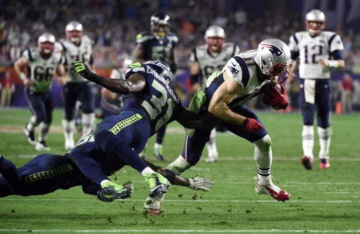 Feb 1, 2015; Glendale, AZ, USA; New England Patriots wide receiver Julian Edelman (11) is tackled by Seattle Seahawks strong safety Kam Chancellor (31) in the fourth quarter in Super Bowl XLIX at University of Phoenix Stadium. Mandatory Credit: Kyle Terada-USA TODAY Sports