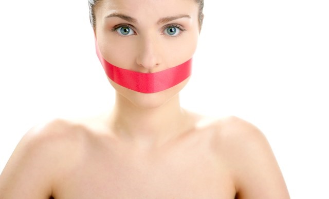 Beautiful woman with red tape on mouth portrait isolated on white