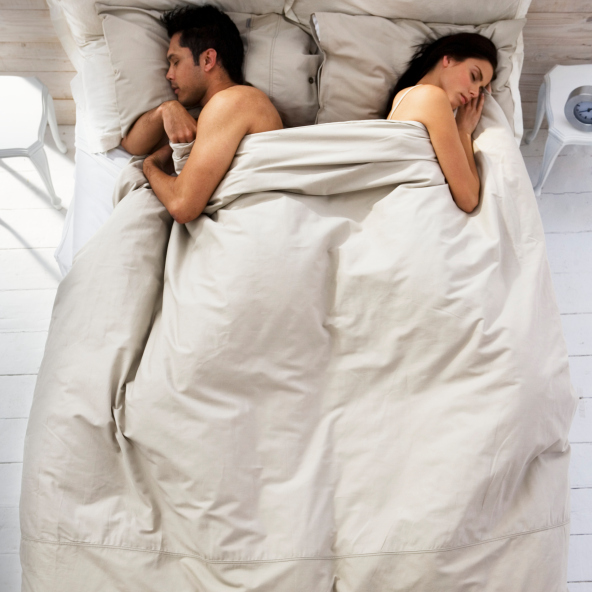 Couple Sleeping on Opposite Sides of Bed