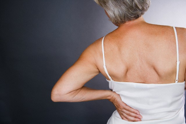 A senior woman with backache --- Image by © I Love Images/Corbis